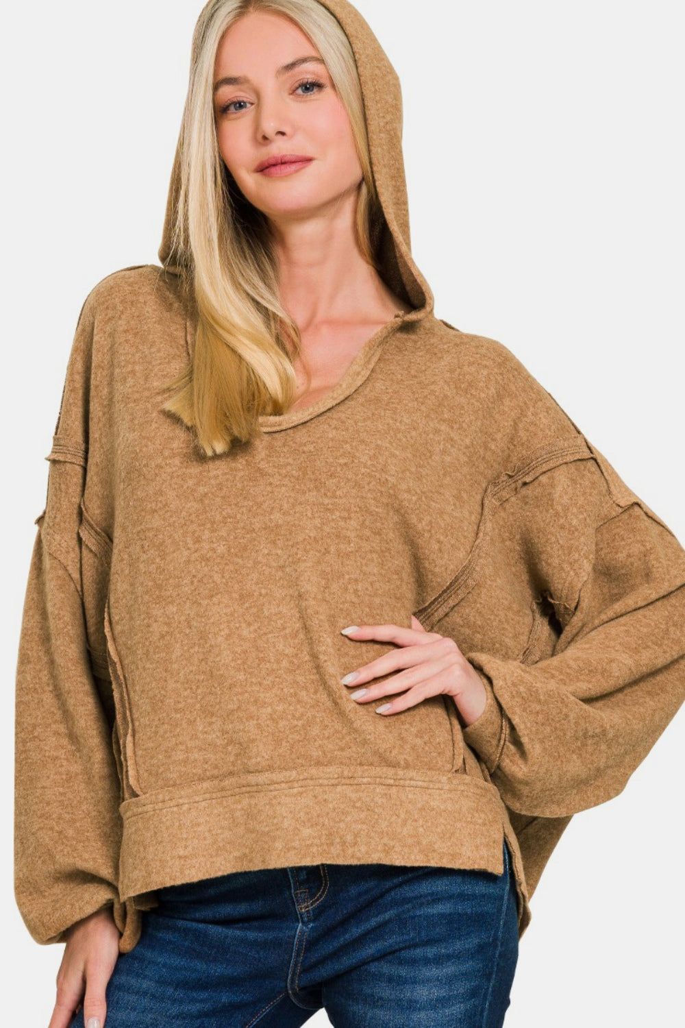 Exposed seam hoodie with balloon sleeves in cozy Hacci fabric.