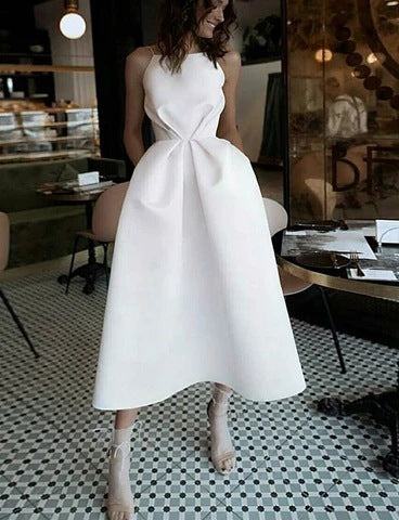 Elegant white polyester dress with unique design, ideal for fashion events.