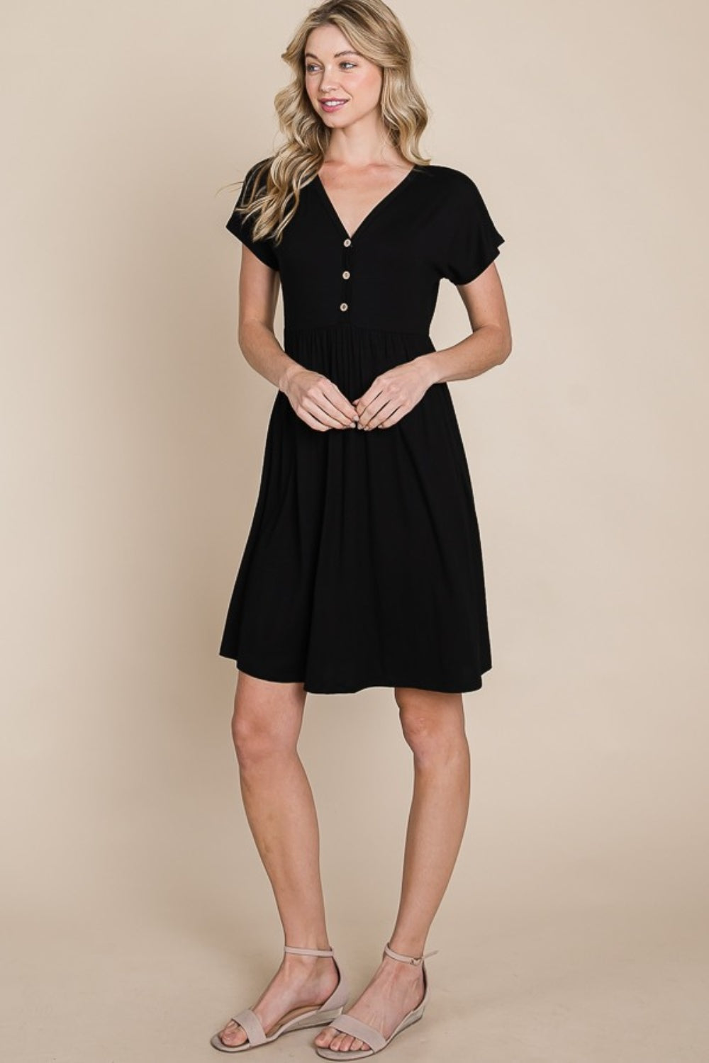 V-Neck short sleeve dress with button details in black.