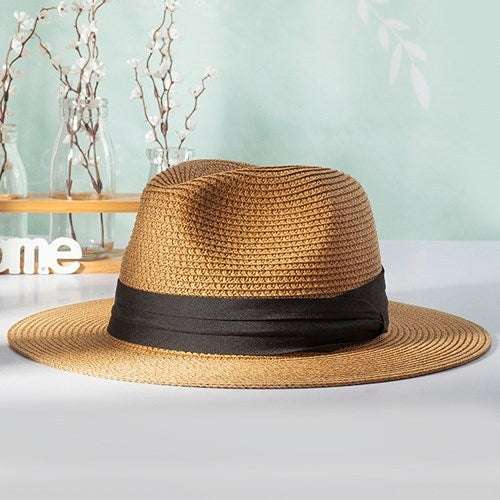 Panama hat with black band and straw design.