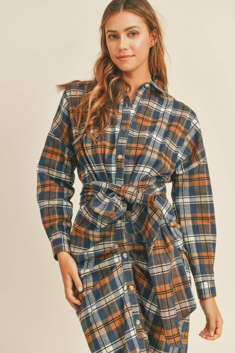 Plaid flannel shirt dress with front tie and button-down design.
