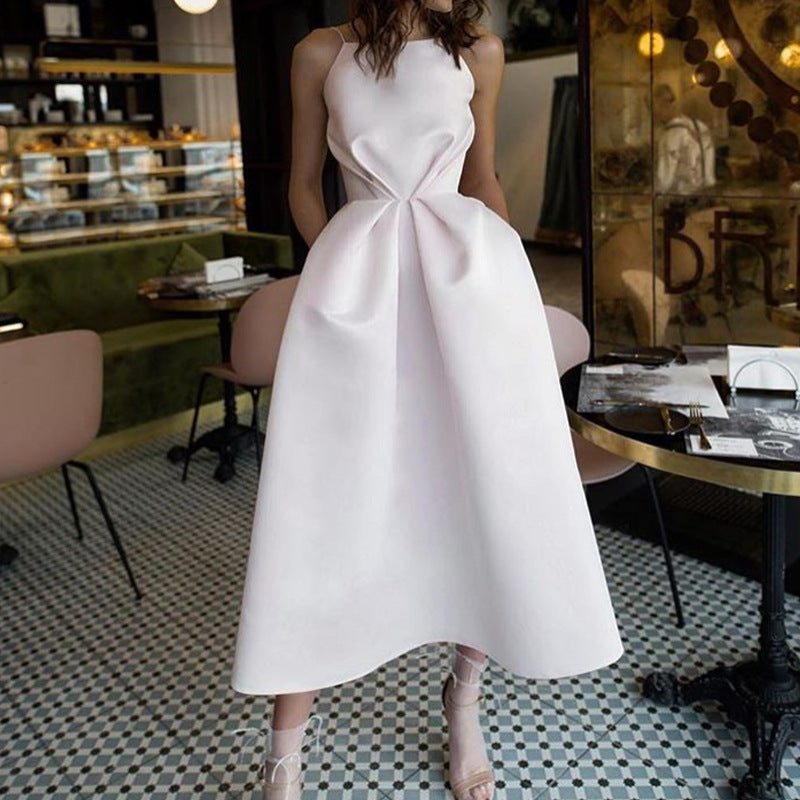 Elegant pink sleeveless dress displayed indoors, highlighting fashion trends.