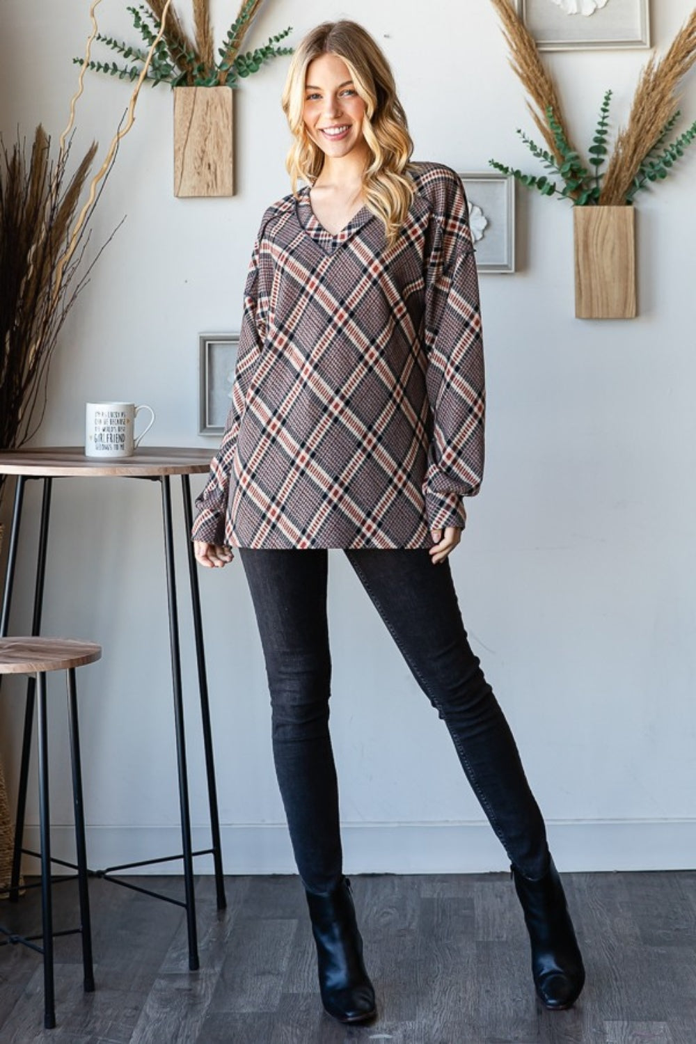 Plaid V-Neck Tee with exposed seams, styled with black jeans and ankle boots.