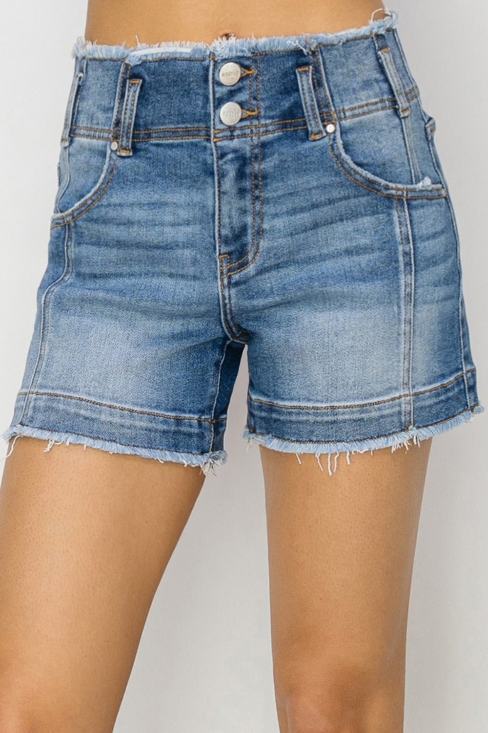 High rise seam detail denim shorts with raw edges and pockets.